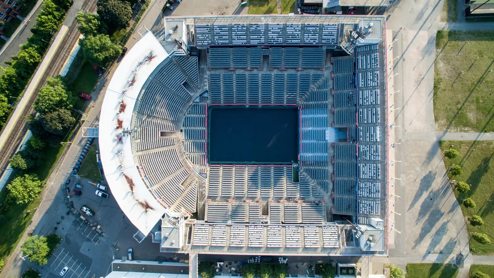 Aerial view of a tennis stadium with a blue centre court surrounded by stands