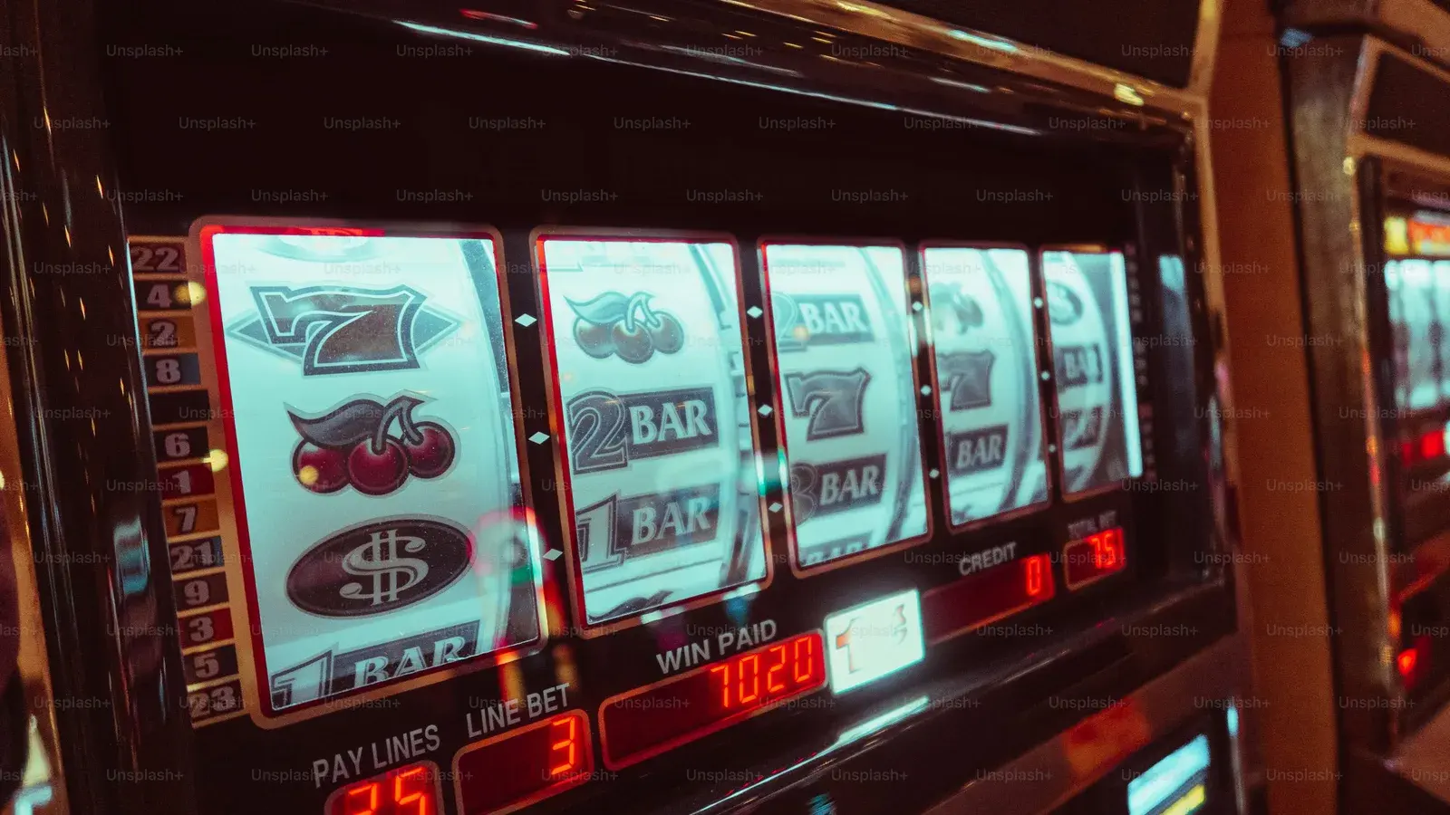 Row of lit slot machine reels showing bars and sevens