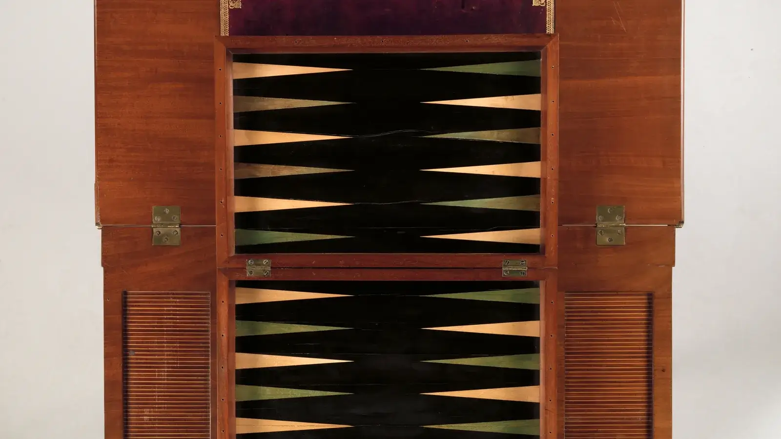 Antique games table opened to show an inlaid backgammon board in wood and black